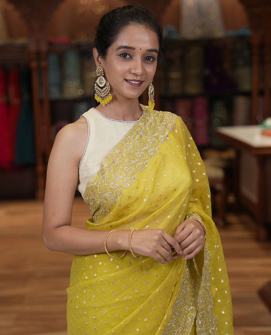 Yellow Fendi Chiffon Saree, Steeped with 1000-Buttas All Over Its Body, Highlighted by a Scallop Embroidered Border, a Self-Pallu, and Paired with a Matching Blouse