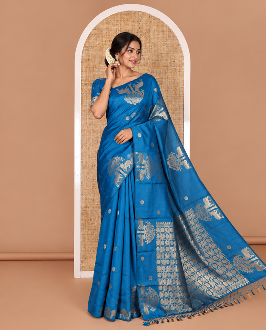 Borderless rama blue peacock, chakra, and pichwai cow buttas zari woven kanchi silk saree, peacock and chakra enclosed checked pallu, and matching blouse