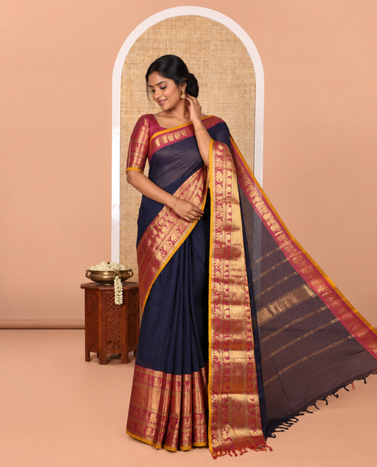 Navy Blue Plain Chettinad Cotton Saree, Complemented by Contrast Traditional Zari Border of Peacock and Elephant Designs, Gleaming Pallu of Stripes, and Paired with a Matching Blouse