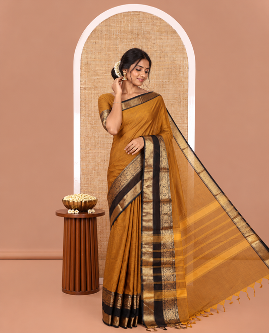 Gold Plain Chettinad Cotton Saree, Complemented by a Contrast Rettai Pettu Traditional Border of Round Peacock Designs, Striped Pallu, and Paired with a Matching Blouse