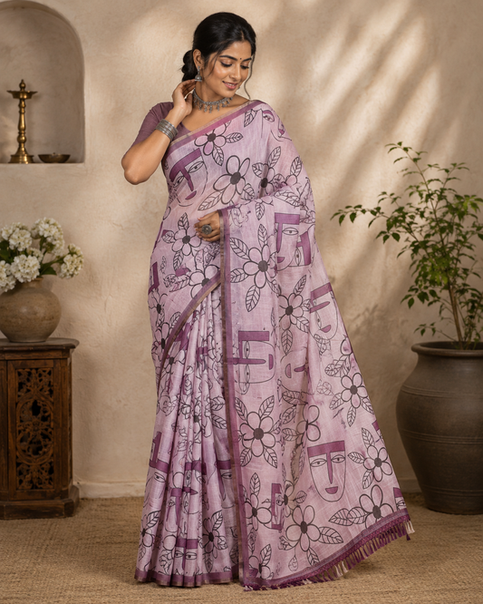 Light Purple Linen Cotton Saree, Featuring Flowers and Faces Printed on Its Body, Subtle Zari Piping Border, Pallu Mirrors the Self-Print, and Comes with a Contrast Blouse