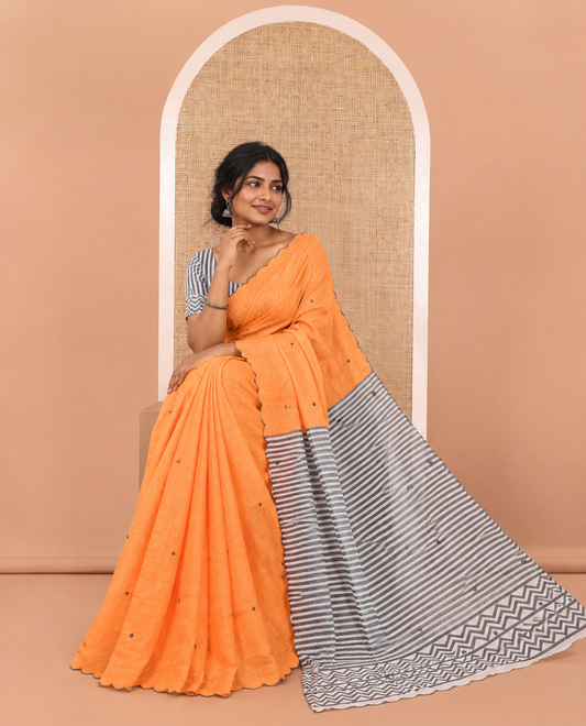 Orange Linen Cotton Saree, Subtly Sparkled with Mirror Work All Over Its Body, Subtly Scallop Border, Complemented by Contrast Pallu of Stripes and Mirror Work, and Paired with a Contrast Geometric Printed Blouse