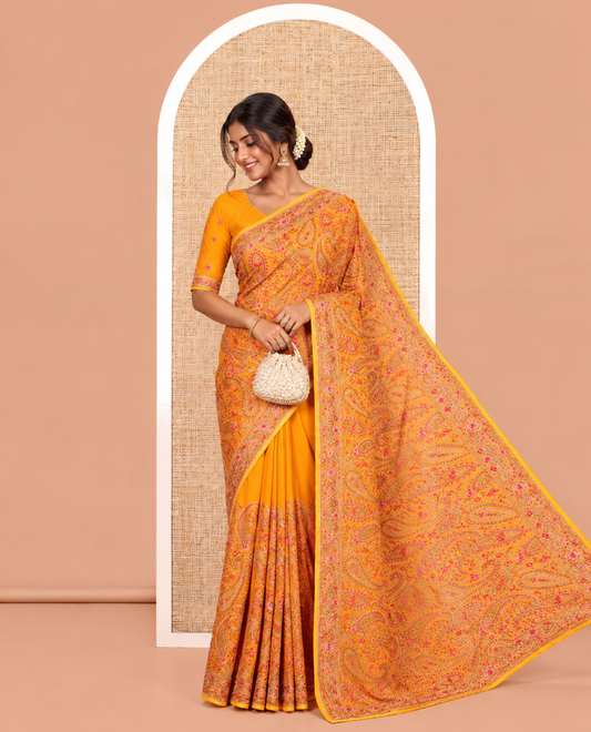 Mustard Georgette Saree, Ornamented with Intricate Paisleys, Kashmir Embroidered and Stone Work on Its Body, a Self-Embroidered Border, and Paired with an Embroidered Blouse