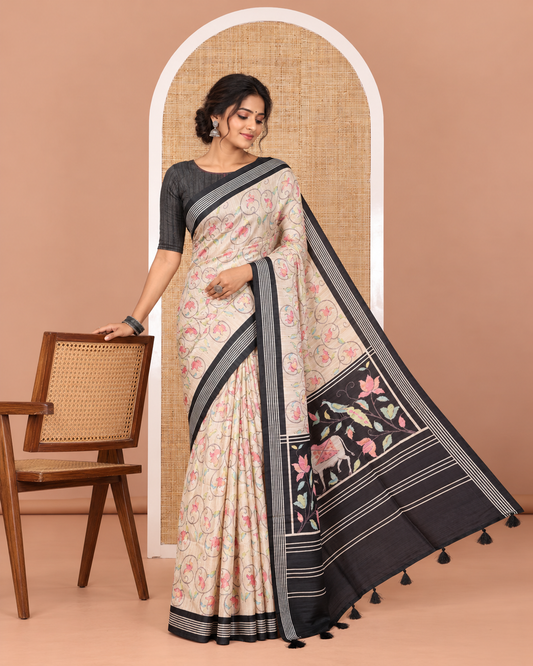 Chikku-black floral vine printed tissue patola saree, contrast striped border, pallu of floral and Pichwai cow motifs print, and a plain blouse