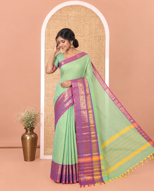 Sea Green Chettinad Cotton Saree, Subtly Sparkled with Stripes on Its Body, Complemented by a Contrast Traditional Design Zari Border, Subtly Striped Pallu, and Paired with a Matching Blouse