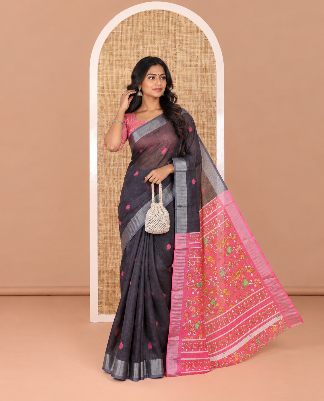 Black floral buttas printed linen cotton saree, zari border, contrast kalamkari floral vine printed pallu, and kalamkari floral vine printed blouse