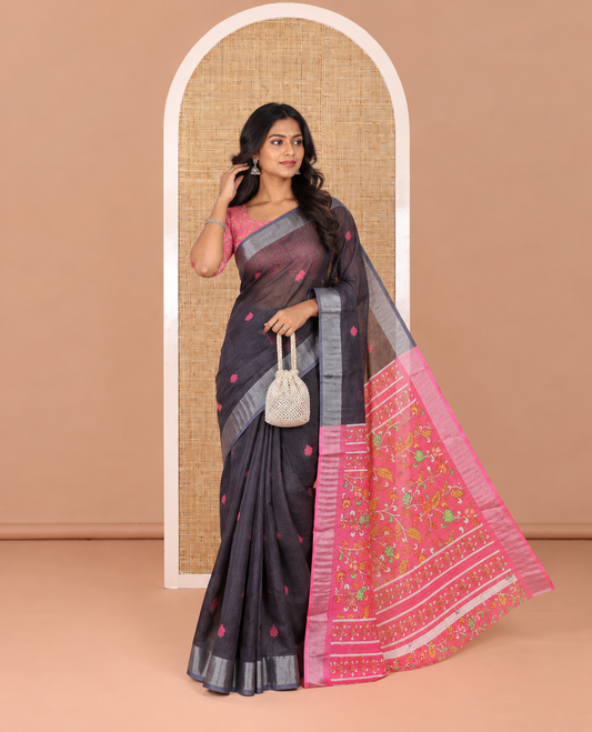 Black floral buttas printed linen cotton saree, zari border, contrast kalamkari floral vine printed pallu, and kalamkari floral vine printed blouse