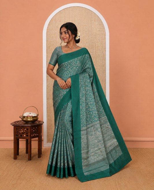 Green Semi-Tussar Saree, Ornamented with Floral Jacquard Design, an Embossed Border, a Floral Pallu, and a Matching Blouse