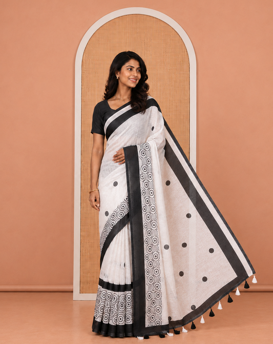 White and Black Linen Cotton Saree, Accentuated with Polka Dot Motifs All Over Its Body, Complemented by Contrast Geometric Patterned Border, a Self-Pallu and Paired with a Contrast Blouse