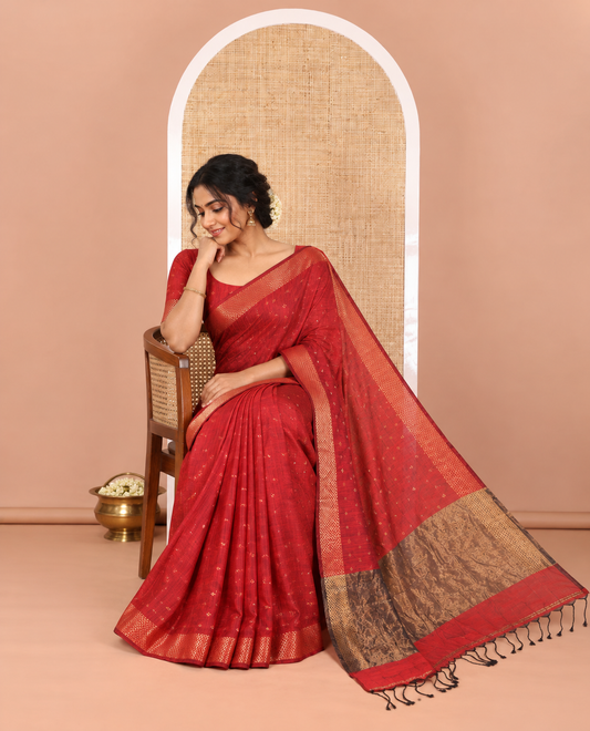 Maroon Khadi Mul Cotton Saree Beautified with Plus-Shaped Zari Buttas Across Its Body, Featuring a Subtle Zari Border Adorned with Triangle Motifs, a Tissue Pallu, and Complemented by a Running Blouse