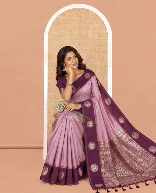 Lavender Elite Soft Silk Saree, Richly Detailed with Zari Buttas and Zari Stripes All Over Its Body, Complemented by a Contrast Temple Border of Round Peacock Designs, Rich Pallu of Peacock Chakram Butta Enclosed Checks, and Paired with a Contrast Blouse