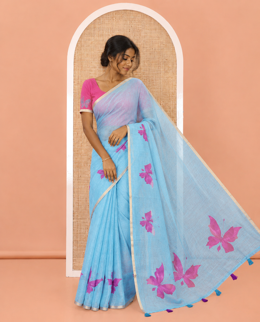 Blue Linen Cotton Saree, Mesmerized with Butterfly Buttas All Over Its Body, Subtle Piping Border, Pallu of Butterfly Print, and Paired with a Contrast Fairy Motifs Printed Blouse