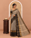 Grey plain chettinad cotton saree, contrast traditional zari border of peacock motifs, striped pallu, and a matching blouse