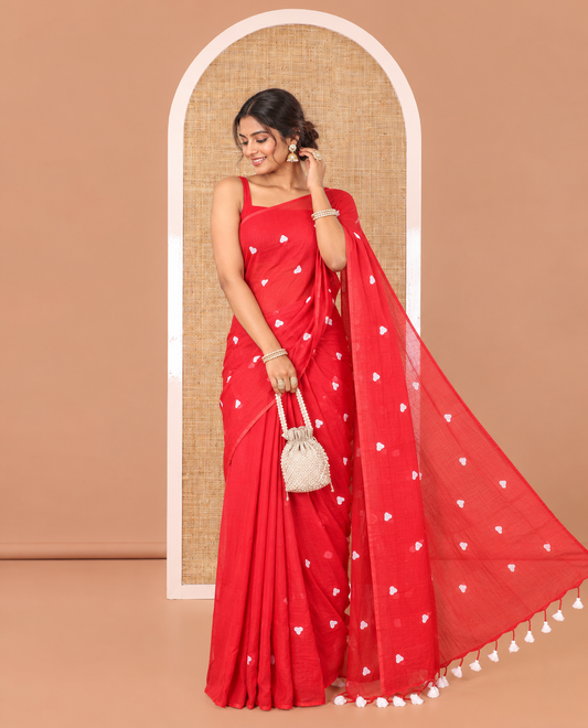 Borderless Red Khadi Mul Cotton Saree, Artfully Designed with Heart Motifs Embroidery Across Its Body, Pallu mirrors the Same Design, and Paired with a Matching Blouse