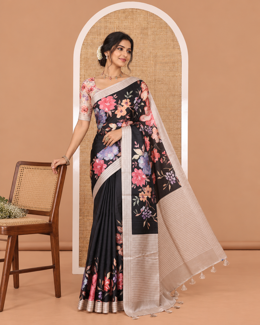 Black kaleidoscopic-colored floral printed fancy tussar saree with contrast border and pallu steeped with dobbly-style buttas, and contrast floral printed blouse