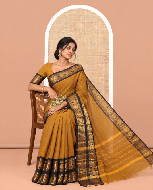 Mustard Plain Chettinad Cotton Saree, Complemented by a Contrast Peacock-Chakram Rettai Pettu Border, and a Matching Blouse