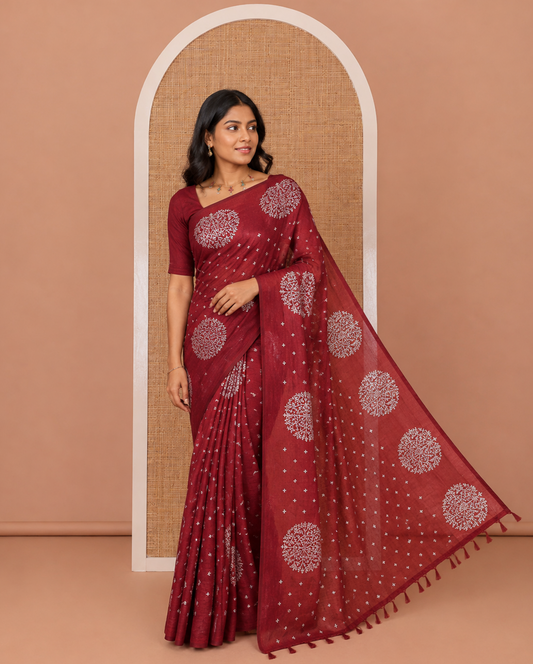 Maroon plus buttas woven Vichitra silk saree, kalpavriksha tree motifs woven on its border, self-pallu, and no blouse