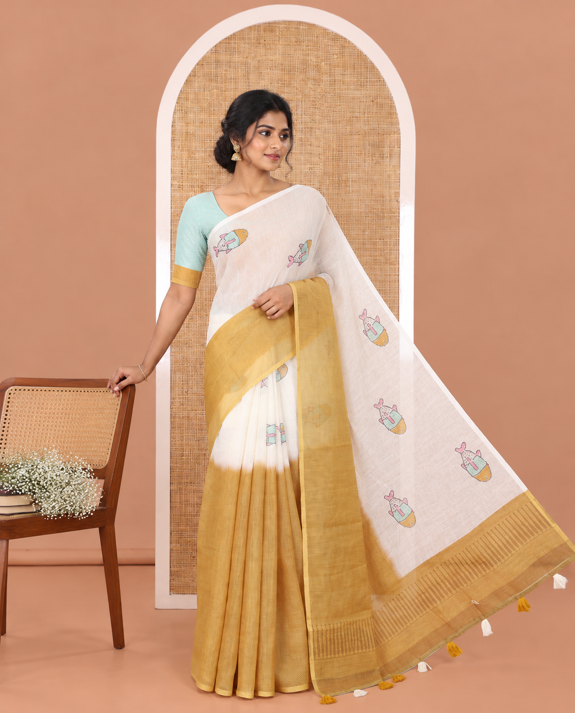 Borderless Cream and Mustard Linen Cotton Saree, Bedecked with Half-and-Half Style Fish Motifs Printed All Over Its Body, Pallu Mirrors the Same Print, and Is Paired with a Contrast Blouse