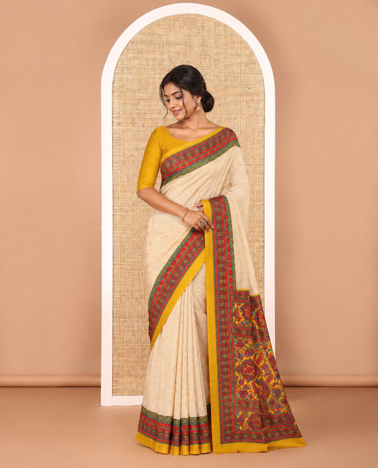 Cream leaf motifs printed crepe silk saree, contrast yellow printed blouse, kaleidoscope coloured intricately printed border & pallu
