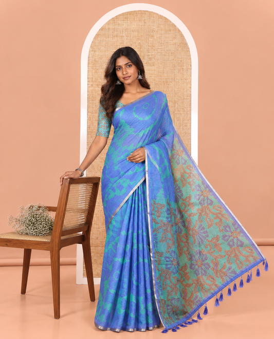 Royal Blue Linen Cotton Saree, Embellished with Shibori Printed on Its Body, Subtle Piping Border, Pallu Features Floral Print, and Paired with a Contrast Floral Printed Blouse