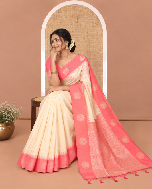 Cream Elite Soft Silk Saree, Beautified with Zari Buttas and Zari Stripes All Over Its Body, Complemented by a Contrast Temple Border of Round Peacock Designs, Rich Pallu of Peacock Chakram Butta Enclosed Checks, and Paired with a Contrast Blouse