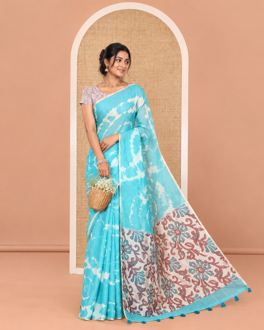 Borderless Blue Linen Cotton Saree, Bedecked with Shibori Printed on Its Body, Complemented by Contrast Floral Printed Pallu, and Paired with a Contrast Floral Printed Blouse
