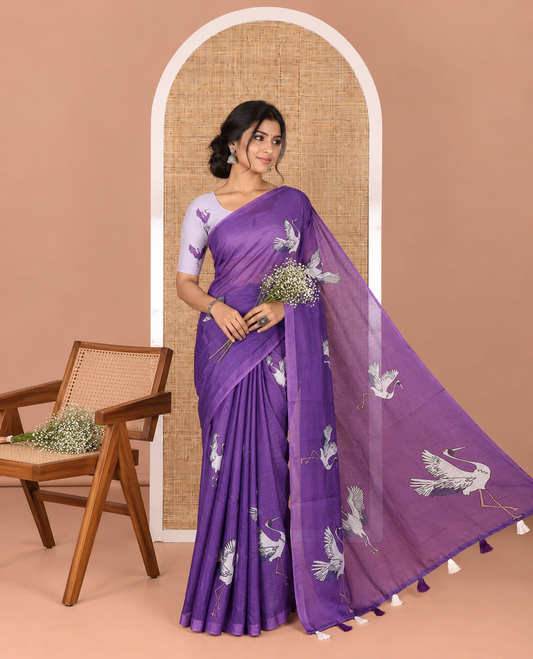 Borderless purple crane motifs printed linen cotton saree, crane motifs printed pallu, and a contrast crane printed blouse