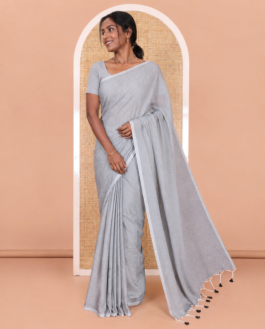 Borderless Sliver Grey Plain Khadi Mul Cotton Saree Features a Self-Pallu with Tassels, and a Matching Blouse