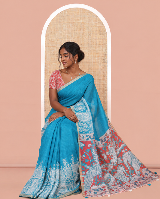 Blue Linen Cotton Saree Features Kalamkari-Style Human Motifs Print, a Piping Border, Contrast Printed Pallu, and Contrast Blouse