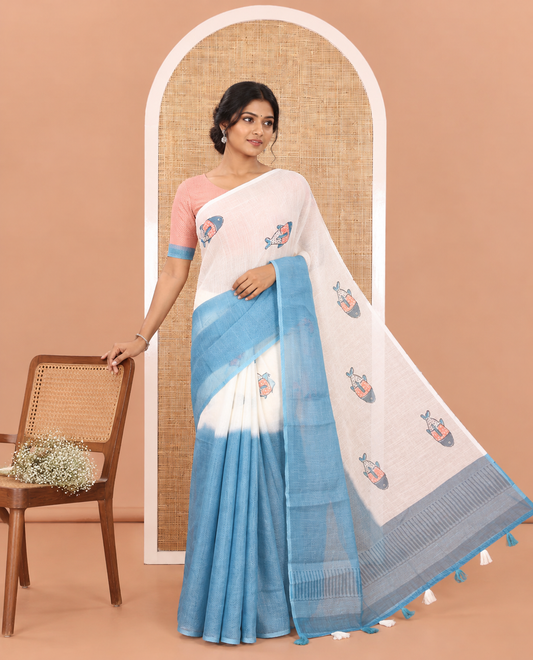Borderless Cream and Blue Linen Cotton Saree, Accentuated with Half-and-Half Style Fish Motifs Printed All Over Its Body, Pallu Mirrors the Same Print, and Is Paired with a Contrast Blouse