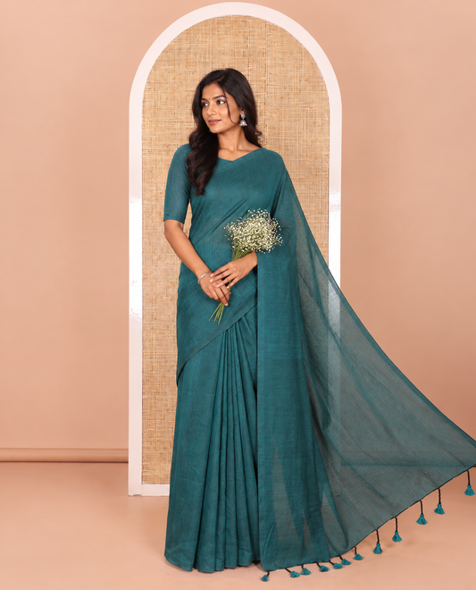 Borderless Peacock Color Plain Khadi Mul Cotton Saree Features a Self-Pallu with Tassels, and a Matching Blouse