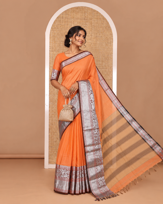 Orange plain mercerised cotton saree, contrast traditional zari border of elephant and peacock designs, striped pallu, and plain blouse