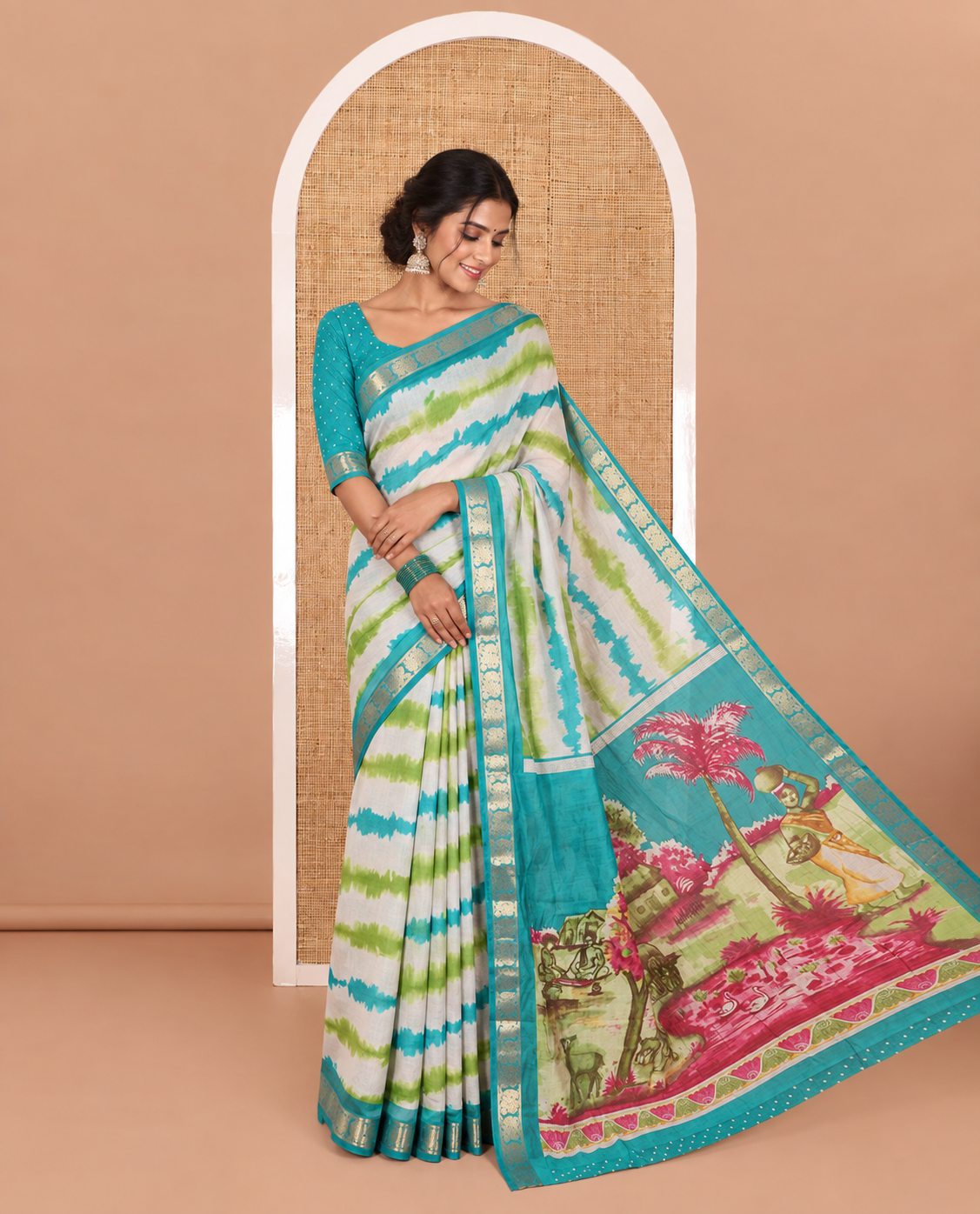 Green shibori printed muslin cotton saree, contrast peacock zari border, village scenery printed pallu, and a contrast polka dotted zari border blouse