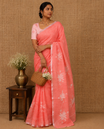 Orange Pichwai lotus printed linen cotton saree, piping zari border, colorful tasselled lotus printed pallu, and a contrast lotus printed blouse