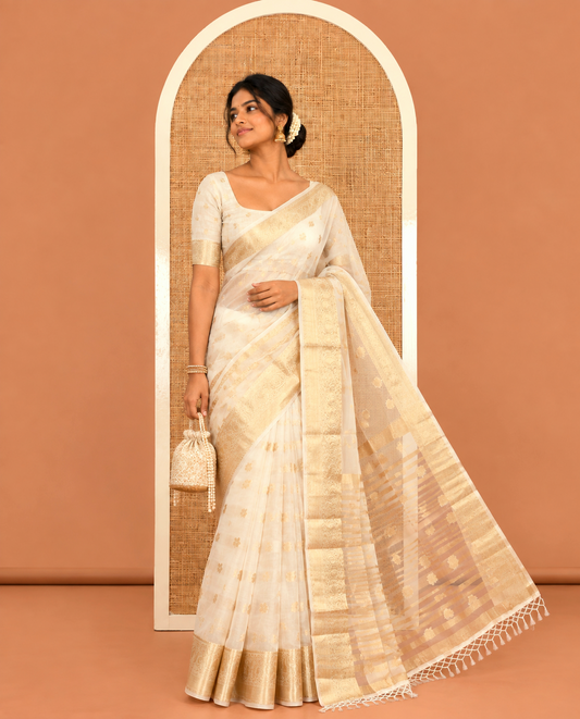 Cream Semi-Organza Saree, Masterfully Woven with Zari Buttas, Highlighted by a Zari Paisley Border, and a Matching Blouse