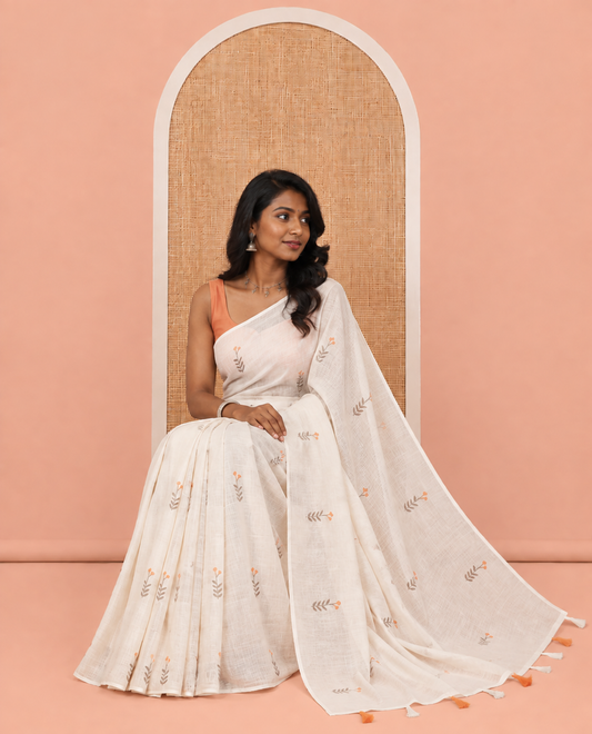 Borderless Cream-Orange Linen Cotton Saree, Prettified with Floral Buttas, a Self-Pallu, and a Contrast Blouse