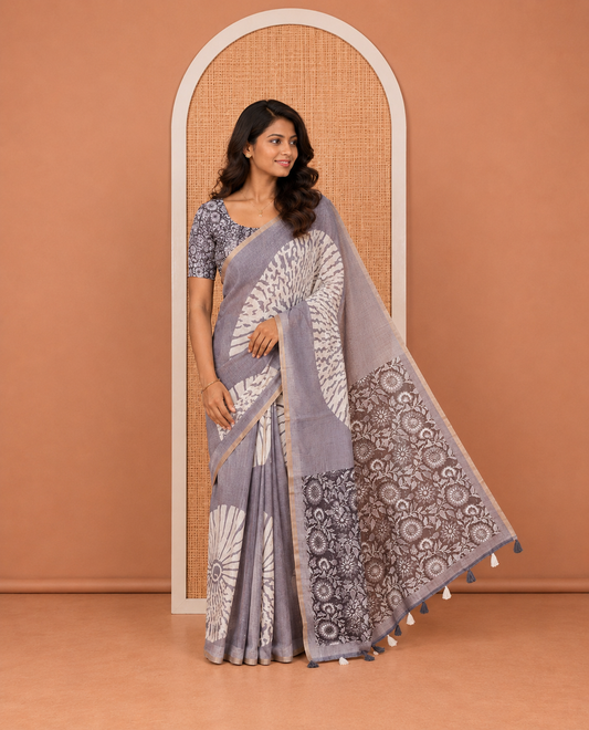 Grey Linen Cotton Saree, Mesmerized with Floral Motifs Printed on Its Body, Subtle Piping Border, Complemented by a Contrast Floral Printed Blouse, and Paired with a Contrast Blouse
