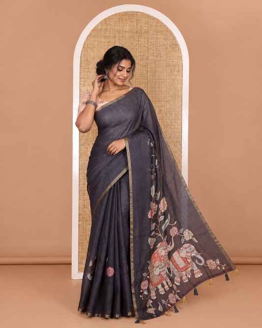 Black kalamkari floral vine, and elephant motifs printed linen cotton saree, piping border, printed pallu, and a contrast elephant motifs printed blouse
