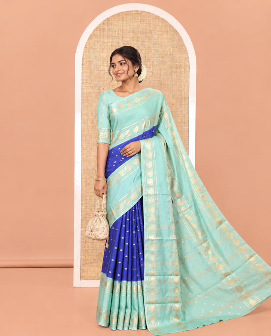 Royal Blue Art Mysore Silk Saree, Enriched with Zari Buttas All Over Its Body, Complemented by a Contrast Rettai Pettu Border of Two-Headed Eagle Designs, Pallu Steeped with Buttas and Stripes, and Paired with a Contrast Blouse