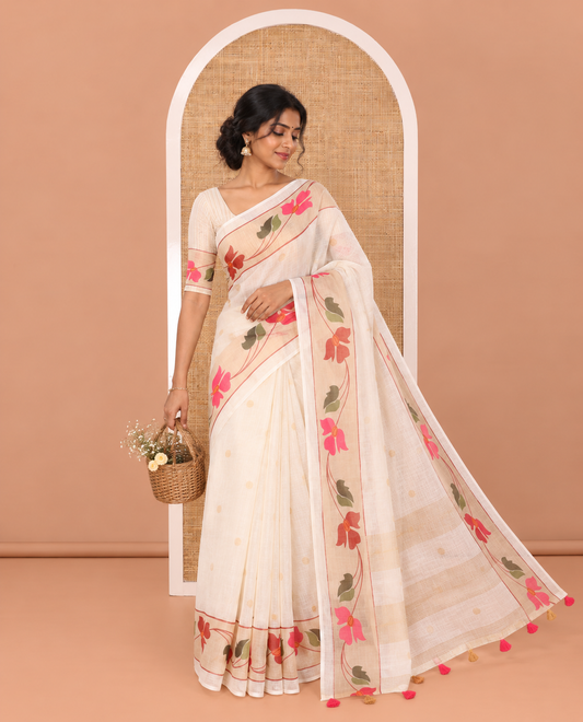 Cream Linen Cotton Saree, Subtly Sparkled with Zari Buttas All Over Its Body, Highlighted by Contrast Floral Creeper Design Border, Subtle Pallu and Paired with a Striped Blouse