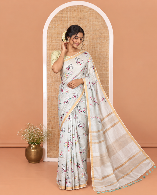 Grey Banana Pith Saree Prettified with Multi-Color Floral Vine Print, Subtle Small Bavanji Border, Gleaming Zari Striped Pallu, and Complemented with a Contrast Floral-Printed Blouse