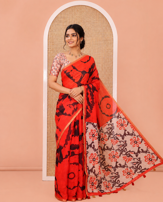 Red Linen Cotton Saree, Showcasing Shibori Printed on Its Body, Subtle Piping Border, Pallu of Floral Vine Print, and Paired with a Contrast Floral Vine Printed Blouse