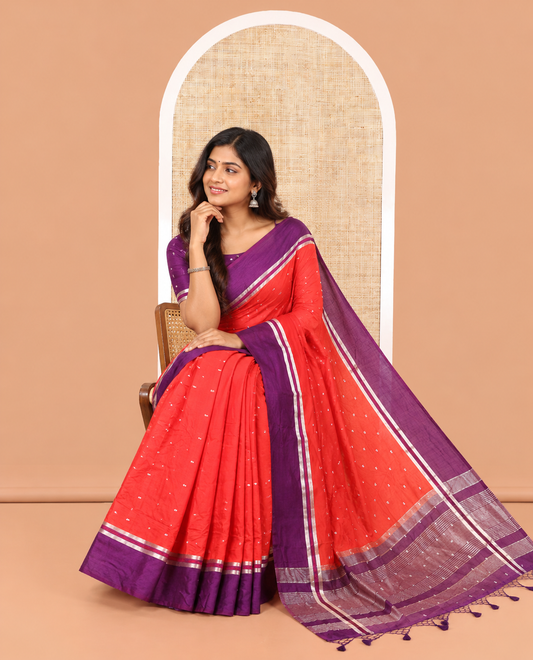 Red Assam Silk Saree, Elevated with Zari Buttas on Its Body, Complemented by Contrast Zari Striped Border, Pallu Steeped with Gleaming Zari Stripes and Buttas, and Paired with a Contrast Blouse