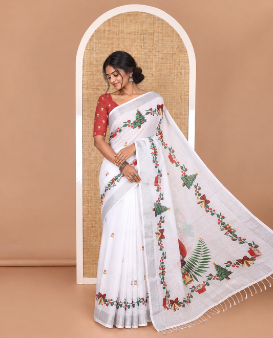 White jingle bell and Christmas tree motifs printed linen saree with bavanji borders, Santa Claus figure printed pallu, and a contrast jingle bell printed blouse