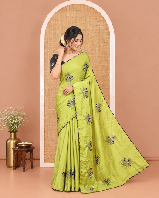 Green Rangoli Chiffon Saree, Elevated with Flower-Style Motifs Embroidered on Its Body, a Subtle Scallop Embroidered Border, a Self-Pallu, and Paired with a Contrast Embroidered Blouse
