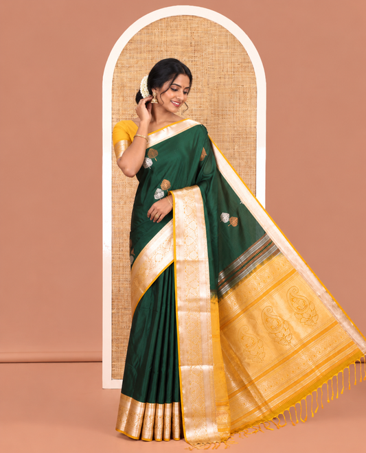 Bottle Green Semi-Soft Silk Saree, Detailed with Zari Buttas All Over Its Body, Complemented by a Contrast Traditional Zari Design Border, Intricately Designed Pallu, and Paired with a Contrast Blouse