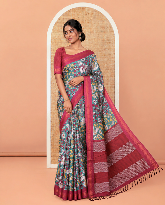 Dark Green Manipuri Silk Saree, Accentuated with Kalamkari-Style Floral Vine and Peacock Motifs Printed All Over Its Body, Complemented by a Contrast Zari Border, Pallu of Chevron Stripes, and Paired with a Contrast Blouse