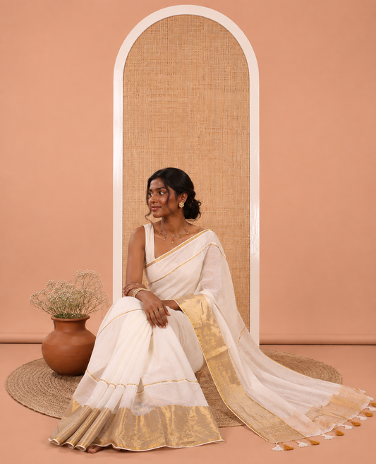 Cream Plain Khadi Mul Cotton Saree, Golden Zari Border, a Self-Pallu with Tassels, and No Blouse