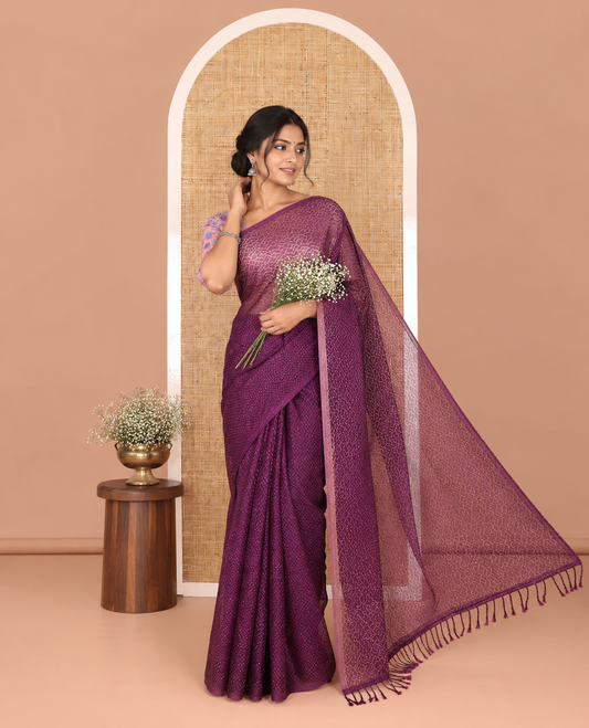 Borderless violet sparkling glitter russel net saree with self-pallu, and a contrast floral printed and zig-zag patterned blouse