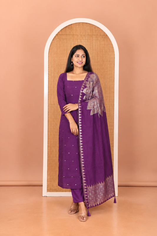 Dark Purple Semi-Silk Material Churidar Features Zari Buttas Top, a Plain Bottom, and a Floral Motif Zari Woven Dupatta